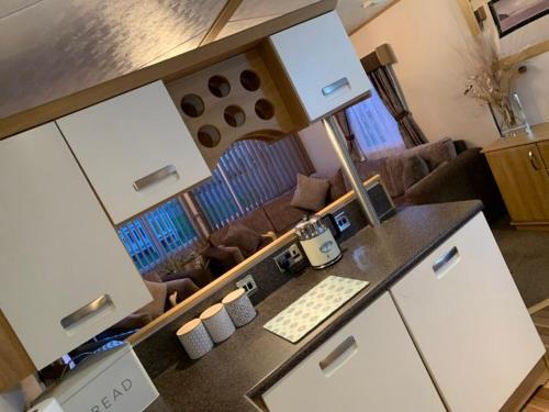 a kitchen with a counter with a keyboard and a desk at B7 Millfields, Ingoldmells - 3 Beds, Ramp Access, Pet Friendly in Ingoldmells