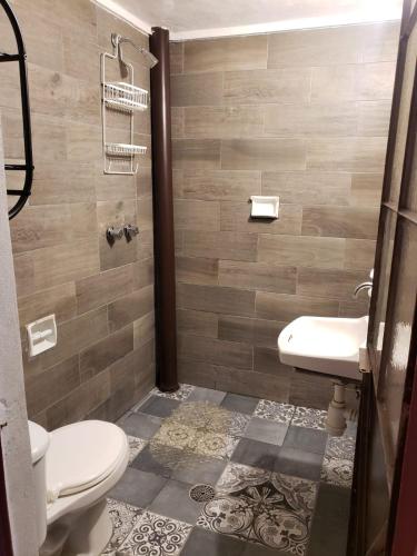 a bathroom with a toilet and a sink at OM Studio in Oaxaca City