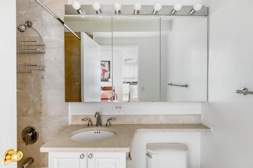 a bathroom with a sink and a mirror at UWS 1BR w Gym Doorman nr Julliard NYC-832 in New York