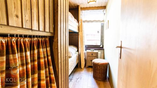 a small room with a bed and a window at Haus Camillo in Saas-Fee