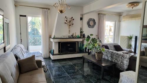 a living room with a couch and a fireplace at Lamia - Premium apartment in Lamía