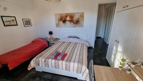 a small bedroom with a bed and a table at Lamia - Premium apartment in Lamía