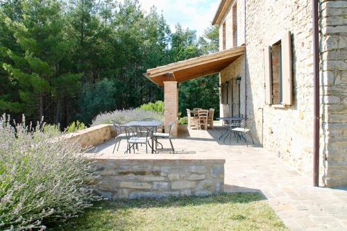 a patio with a table and chairs and a building at Torricella in Città di Castello