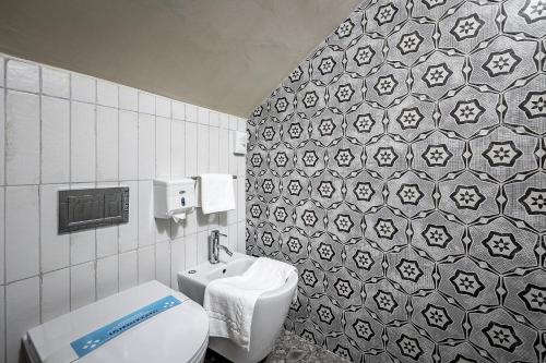 a bathroom with a toilet and a sink at Hotel Duomo Firenze in Florence
