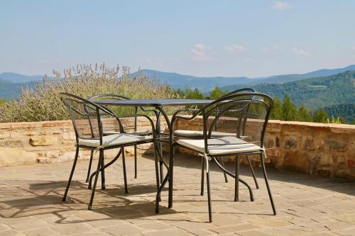 two chairs and a table with a view of mountains at Torricella in Città di Castello