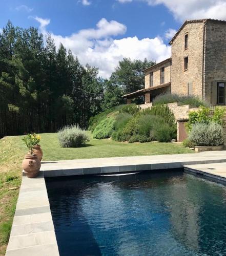a swimming pool in front of a house at Torricella in Città di Castello
