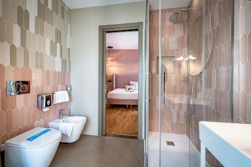 a bathroom with a toilet and a sink and a shower at Hotel Duomo Firenze in Florence