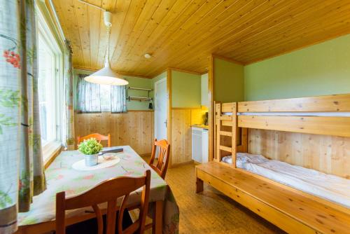 um quarto com um beliche, uma mesa e uma cozinha em Byske Havsbad em Byske