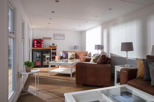 a living room with a couch and a table at Gyllyngvase House in Falmouth