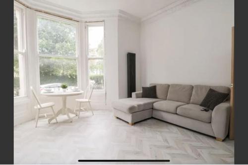 a living room with a couch and a table at Searenity at Southcliff in Scarborough