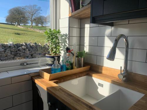 a kitchen counter with a sink and a window at Primrose Cottage - Tideswell, Peak District in Tideswell