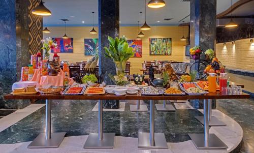 a buffet of food on a table in a store at Amarpreet, Chhatrapati Sambhajinagar - AM Hotel Kollection in Aurangabad