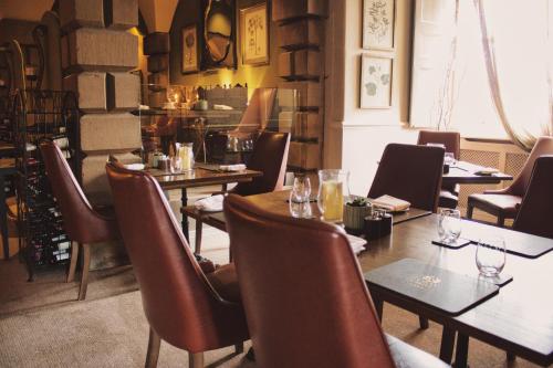 a restaurant with tables and chairs in a room at Lumley Castle Hotel in Chester-le-Street