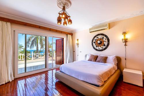 a bedroom with a bed and a view of the ocean at Sharm and Charme at Sharm El Sheikh in Sharm El Sheikh