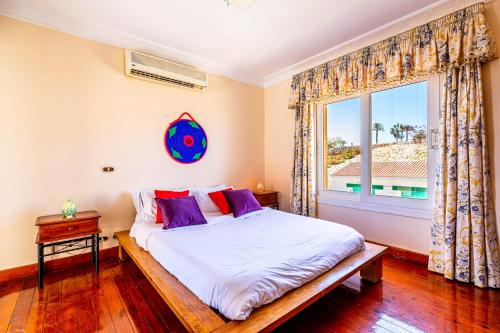 a bedroom with a bed and a large window at Sharm and Charme at Sharm El Sheikh in Sharm El Sheikh