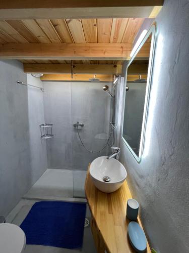a bathroom with a white sink and a shower at yoco in Eleonas