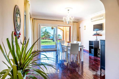 a dining room and living room with a table and chairs at Sharm and Charme at Sharm El Sheikh in Sharm El Sheikh