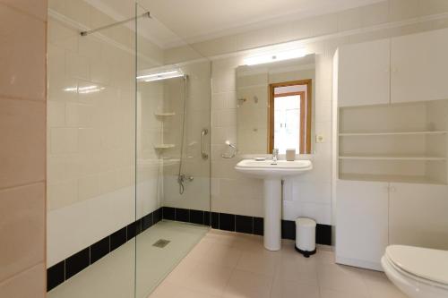 a bathroom with a sink and a shower and a toilet at Pool and sea views apartment with 1 parking space in Tossa de Mar