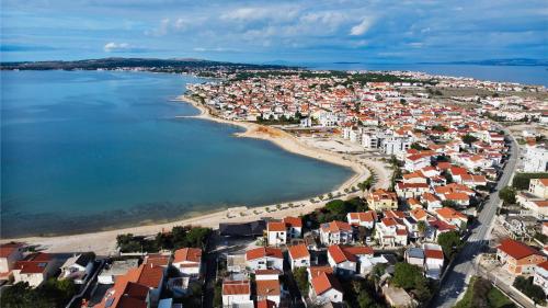 an aerial view of a town with a beach at Number One Apartments in Vir