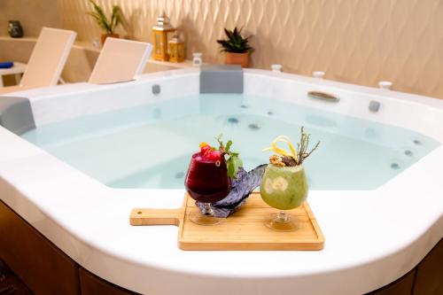 a bath tub with two fruits and vegetables in it at Golden Tulip Opera Alger in Ouled Fayet