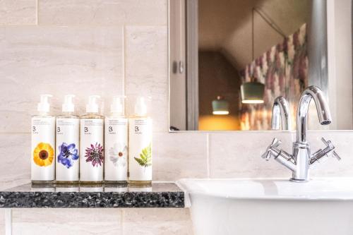 a bathroom counter with a sink and a mirror at The Cricketers Clavering in Clavering