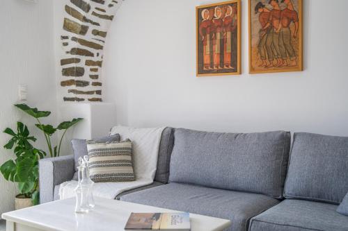 a living room with a couch and a table at Anthemion Paros - Villas & Suites in Agia Irini Paros