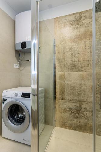 a washer and dryer in a bathroom with a washing machine at BLUE SKY in Cres