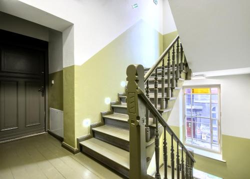 a staircase in a building with a black door at Studio Mini Apart 6.2 - ACCO RENT in Gdańsk