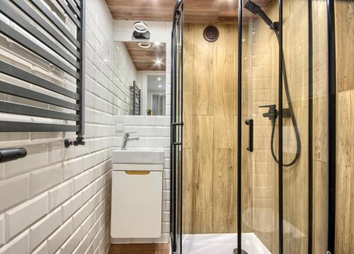 a bathroom with a shower and a sink at Studio Mini Apart 6.2 - ACCO RENT in Gdańsk