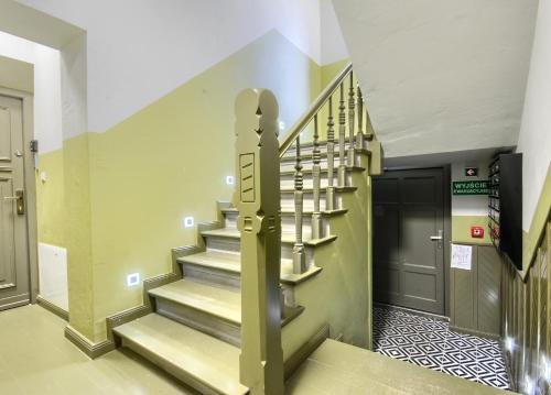 a spiral staircase in a hallway with a door at Studio Mini Apart 6.2 - ACCO RENT in Gdańsk
