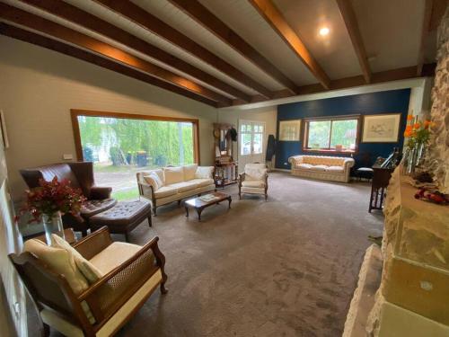 a large living room with couches and chairs at The Barn, Bowral in Bowral