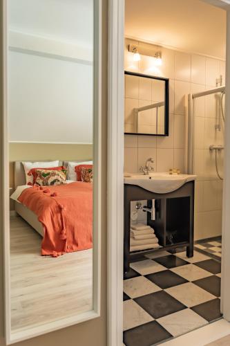 a bedroom with a bed and a sink and a mirror at Hotel Restaurant Toxopeus in Anjum