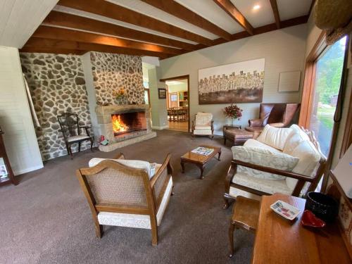a large living room with a stone fireplace at The Barn, Bowral in Bowral
