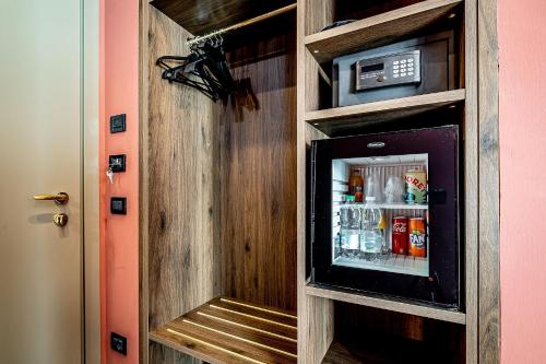 a drink cabinet with a refrigerator in a room at Hotel Duomo Firenze in Florence