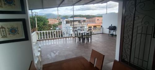 a balcony with a table and chairs on it at Apartamento Fresco con Terraza-tipo loft in Alto de Garzón