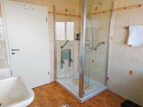 a bathroom with a shower with a glass door at Apartments im Taunus in Neu-Anspach