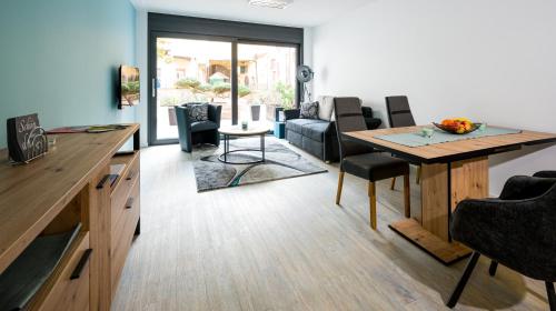 a living room with a table and a couch at Apartment Magnolia in Karlstadt