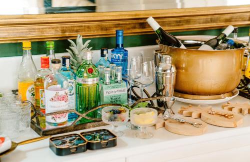 a counter with a bunch of bottles and glasses at Last Word Constantia in Cape Town