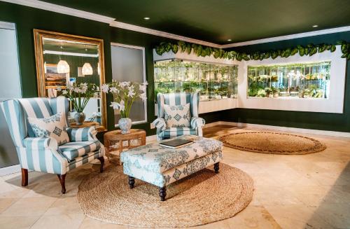 a living room with two chairs and a coffee table at Last Word Constantia in Cape Town