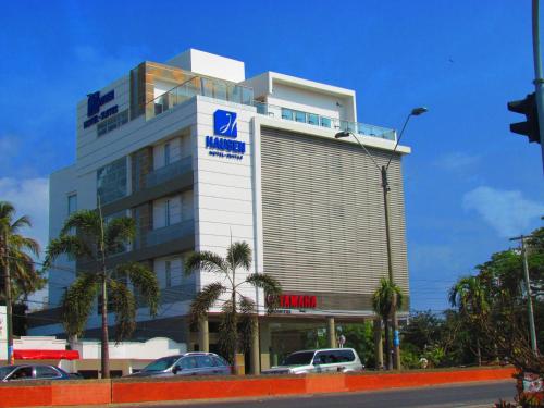 a building with a sign on the side of it at Hausen Hotel - Suites in Montería