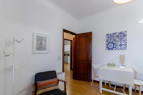 a living room with a table and a chair at Apartment close to the Ria de Aveiro, São Jacinto in Aveiro