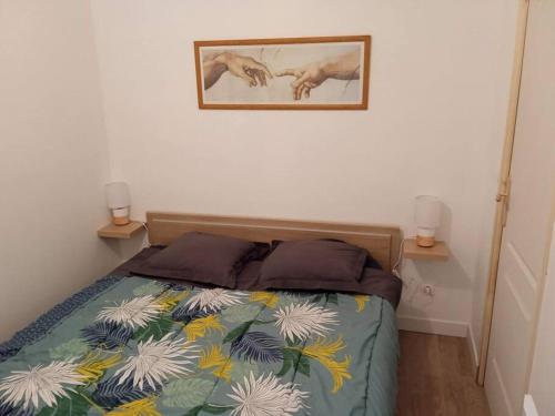 una camera con un letto e due lampade a muro di Petit logement avec entrée indépendante a Vellefrie