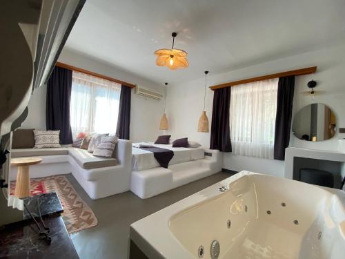 a large living room with a tub and a couch at Tomsan Suites & Villas Akyaka in Akyaka