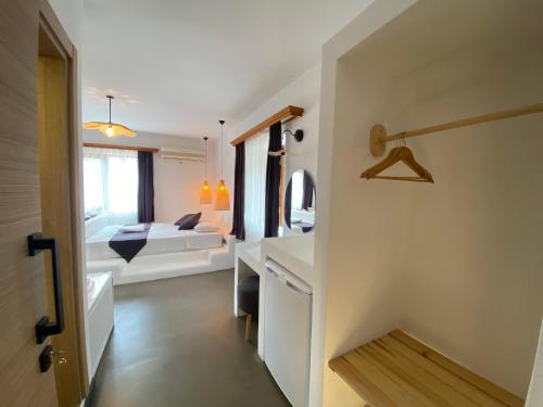 a small room with a bed and a bathroom at Tomsan Suites & Villas Akyaka in Akyaka