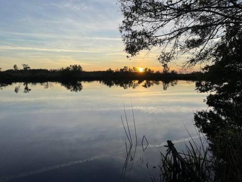 a view of a lake with the sunset in the background at Waterfront Condo #10 in Punta Gorda