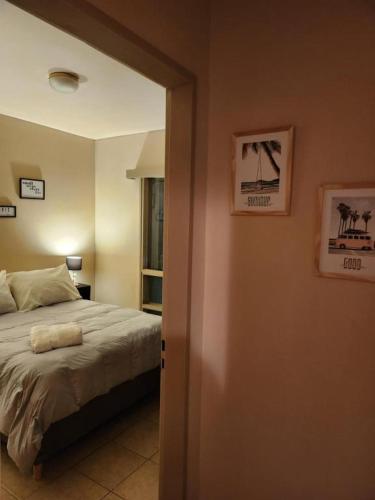 a bedroom with a bed and a room with a window at Donde nos quedamos en Mendoza in Mendoza