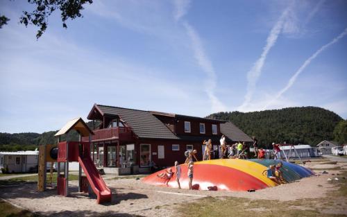 a group of people playing on a playground at Solstrand Camping in Vigeland