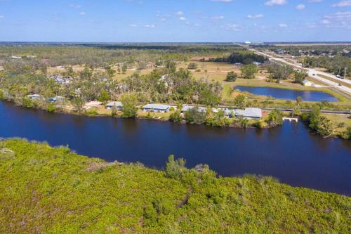 an aerial view of a river with trees and a highway at Waterfront Condo #7 in Punta Gorda