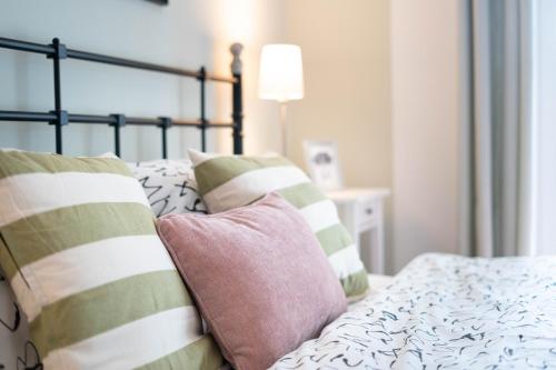 a bedroom with a bed with pillows on it at Alpine apartments Marcella in Žirovnica