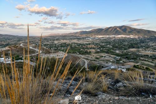 a view of a city from the top of a hill at Tottam Art & Healthy Garden in Málaga